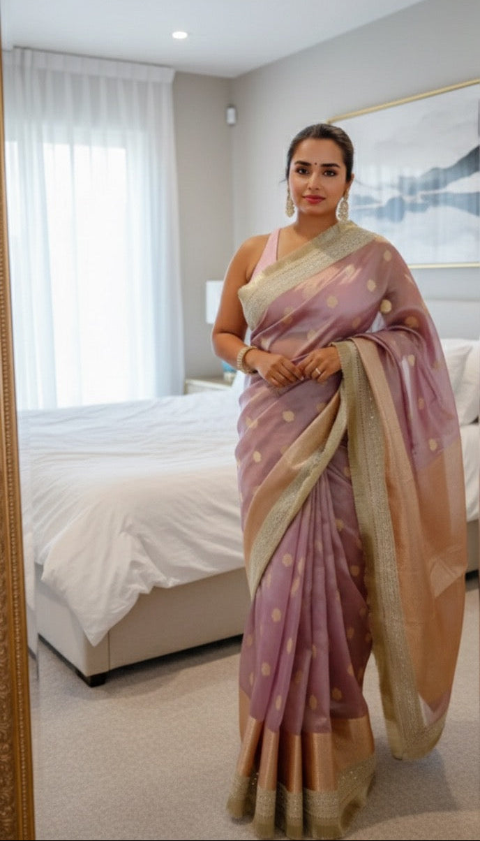 Woman wearing a pink saree in a bedroom setting